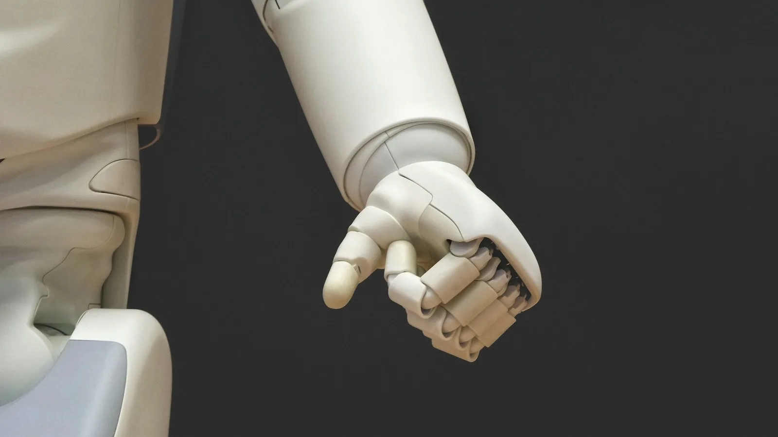 La mano de un robot fotografiada sobre fondo oscuro