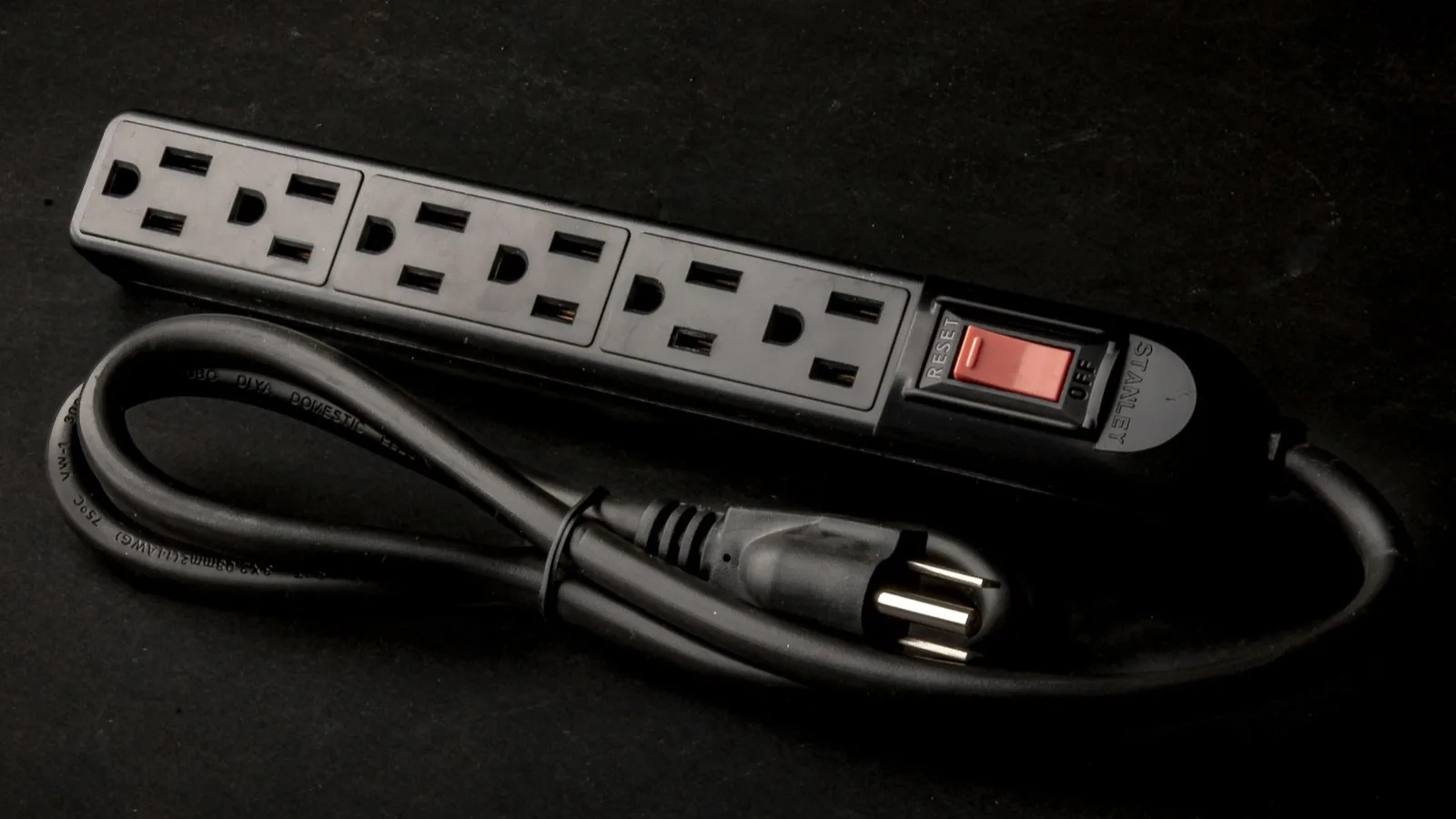 Un cable eléctrico desenchufado sobre fondo oscuro
