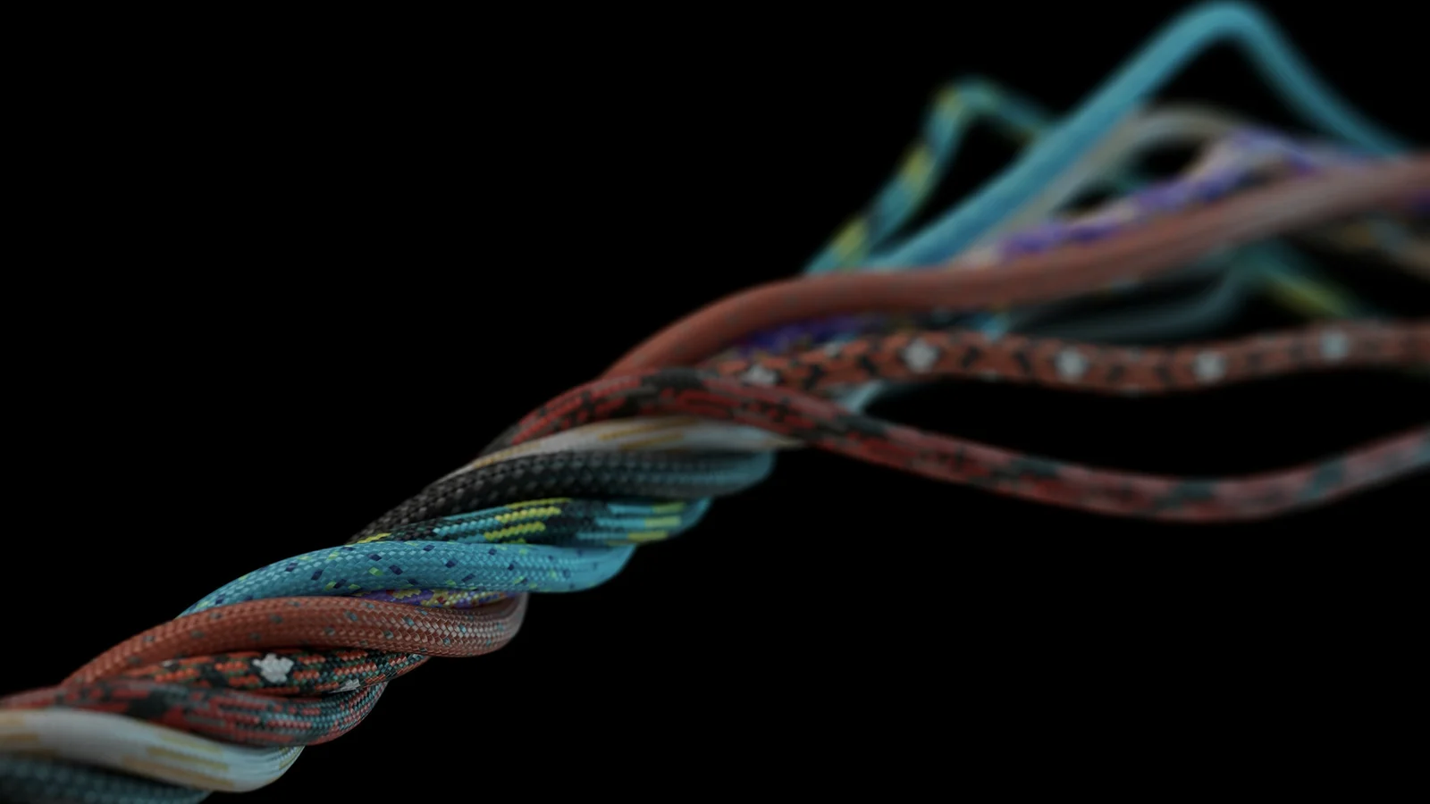 Cordones trenzados de varios colores que se entrelazan y se separan sobre un fondo negro.